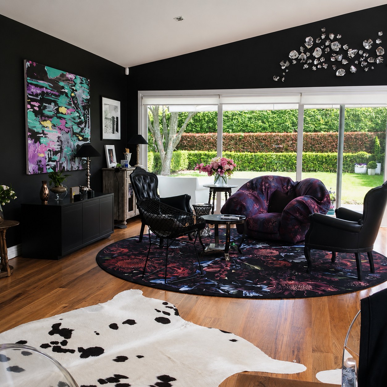 Dramatic dark living room with plum velvet seating and bold abstract artwork